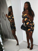 Model wearing the Midnight Flame Bodycon Dress with vibrant flame print, showcasing a stylish look.