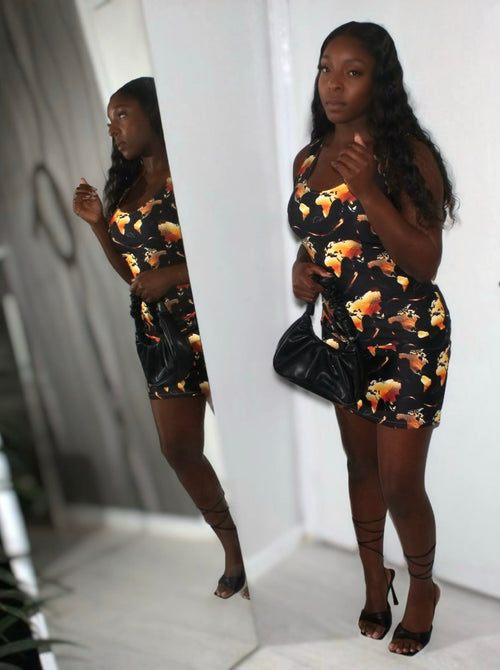Model wearing the Midnight Flame Bodycon Dress with vibrant flame print, showcasing a stylish look.