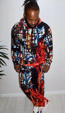 Man wearing the Divine Fire Men’s Hoodie showcasing an urban print with vibrant flames and abstract designs.