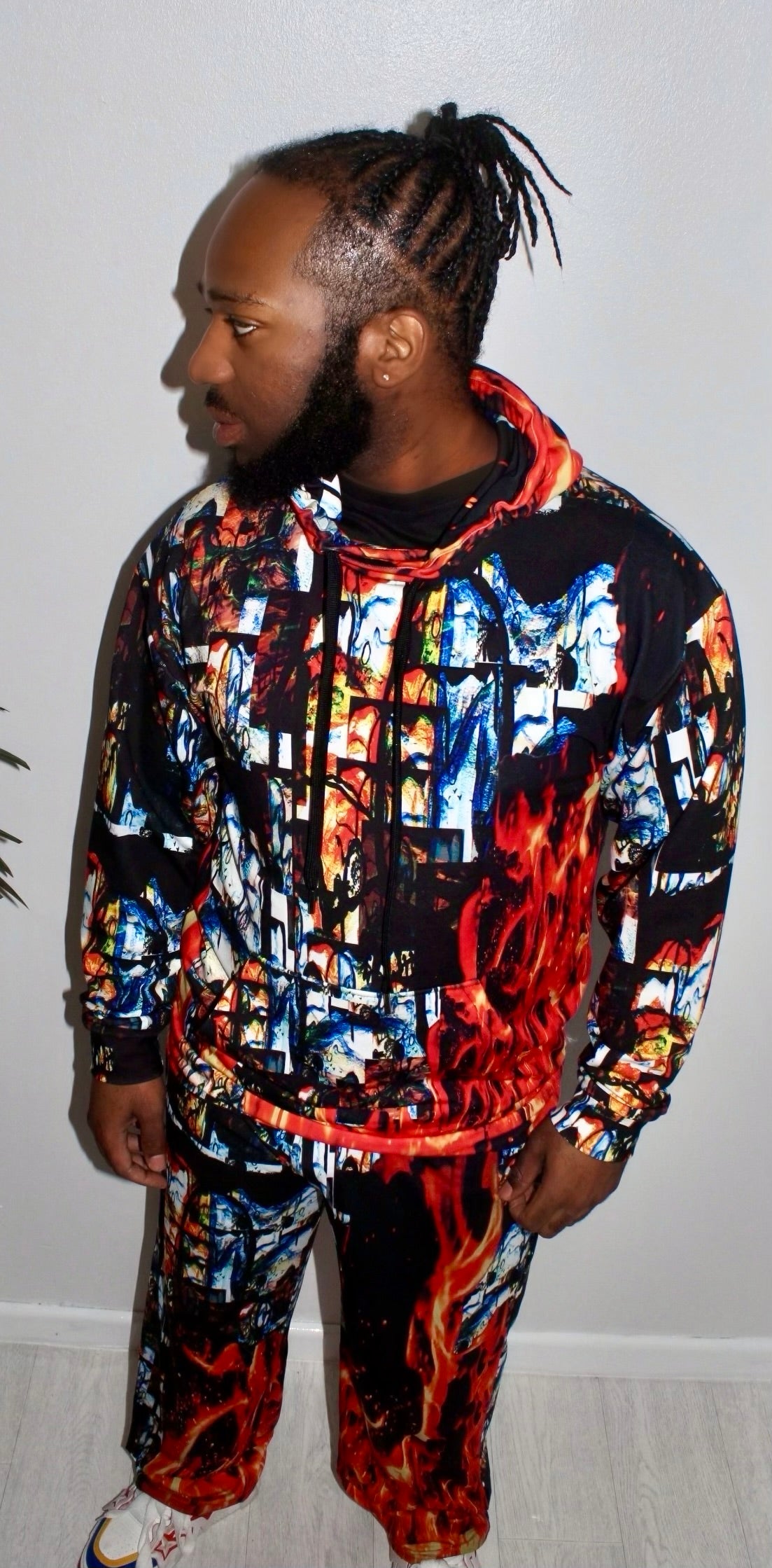 Model wearing the bold Divine Fire Men’s Hoodie with vibrant print, showcasing urban sophistication and style.