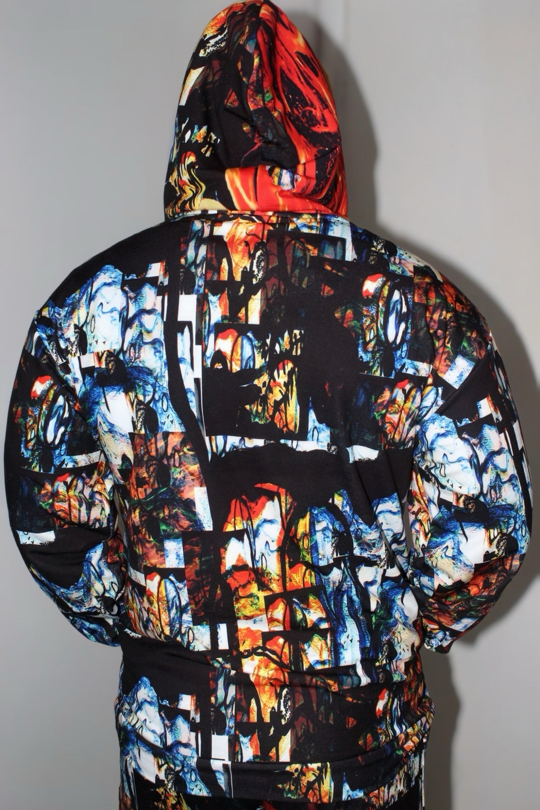 Back view of Divine Fire Men’s Hoodie featuring vibrant abstract print and urban style design.